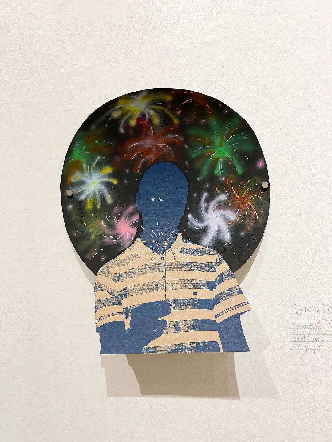 Cut-out style portrait of a person against a circular background filled with colourful fireworks