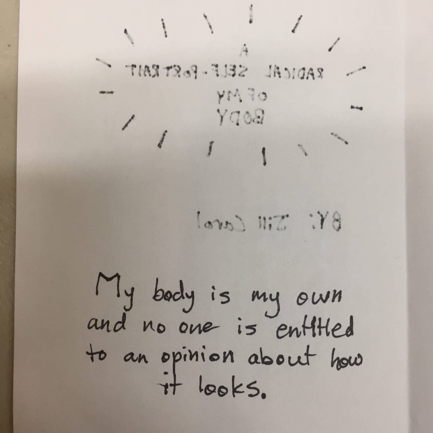 A handwritten note says, My body is my own and no one is entitled to an opinion about how it looks. Above, reversed text reads “A RADICAL SELF-PORTRAIT OF MY BODY” with radiating lines—a powerful statement on art education.