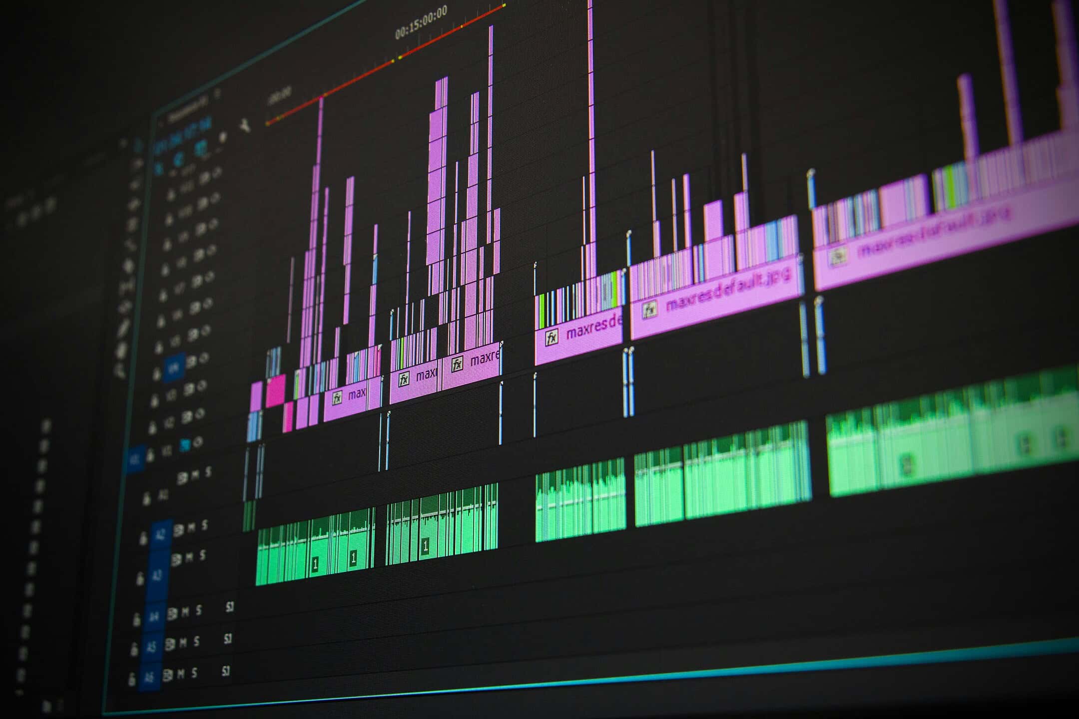 A close-up of a computer screen displaying video editing software, showing multiple audio and video tracks.