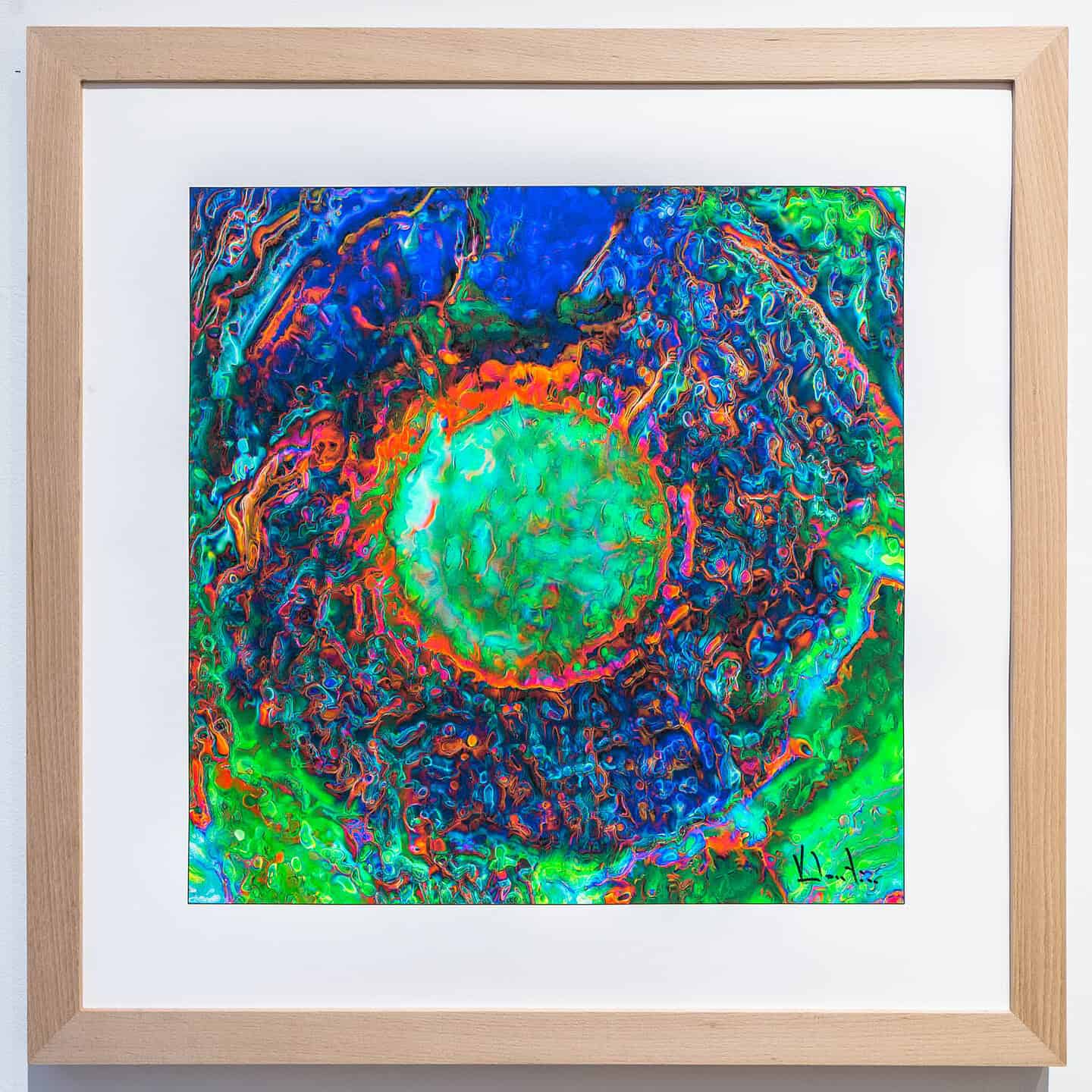 A framed digital artwork featuring a vibrant, glowing green orb in the centre, surrounded by concentric rings of bright blue, orange, and red psychedelic patterns.