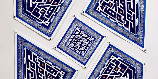 Blue geometric prints arranged in a clustered formation, each featuring maze-like patterns within angular shapes